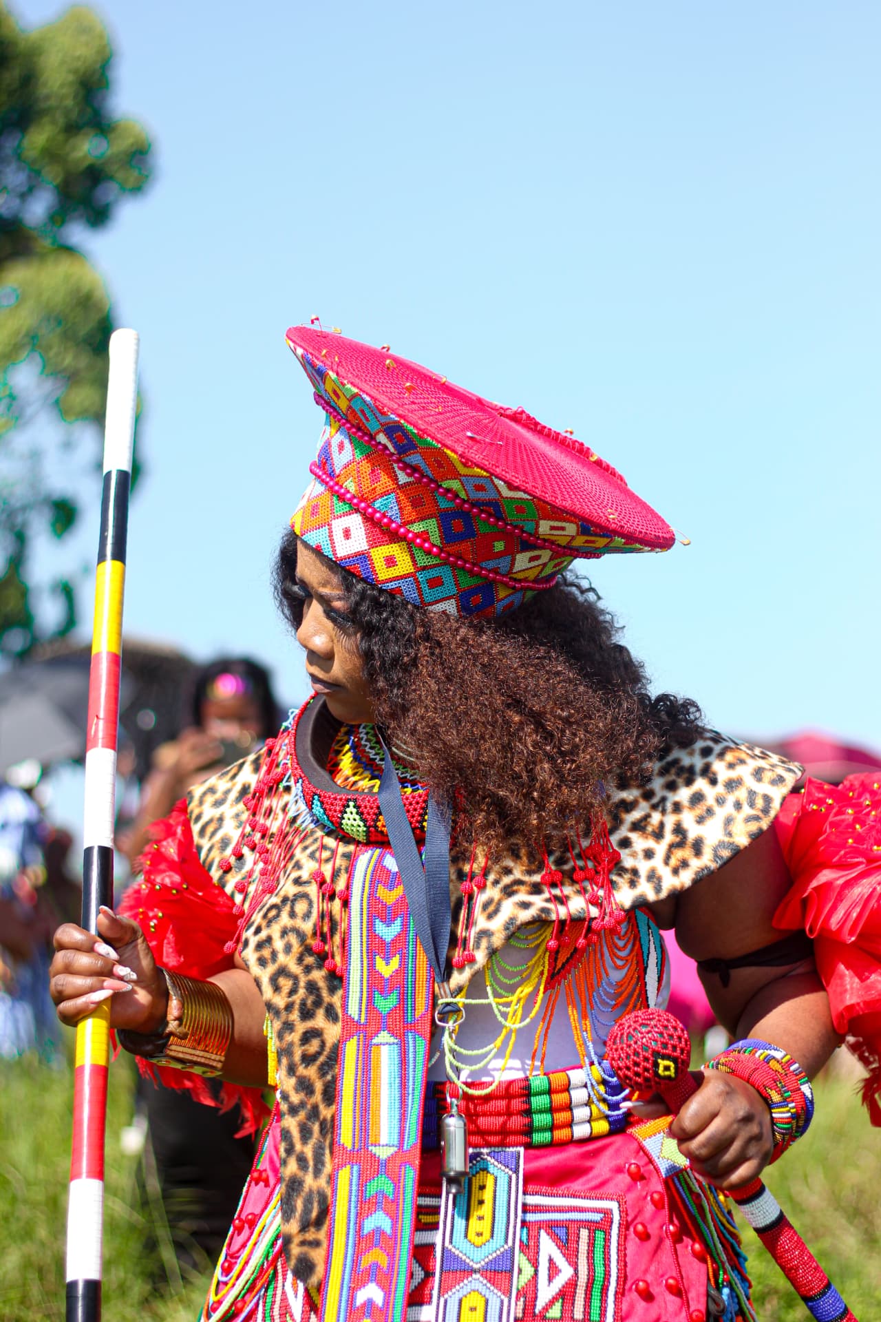 Profile portrait of a celebrant in beaded Zulu headpiece and leopard-print cape