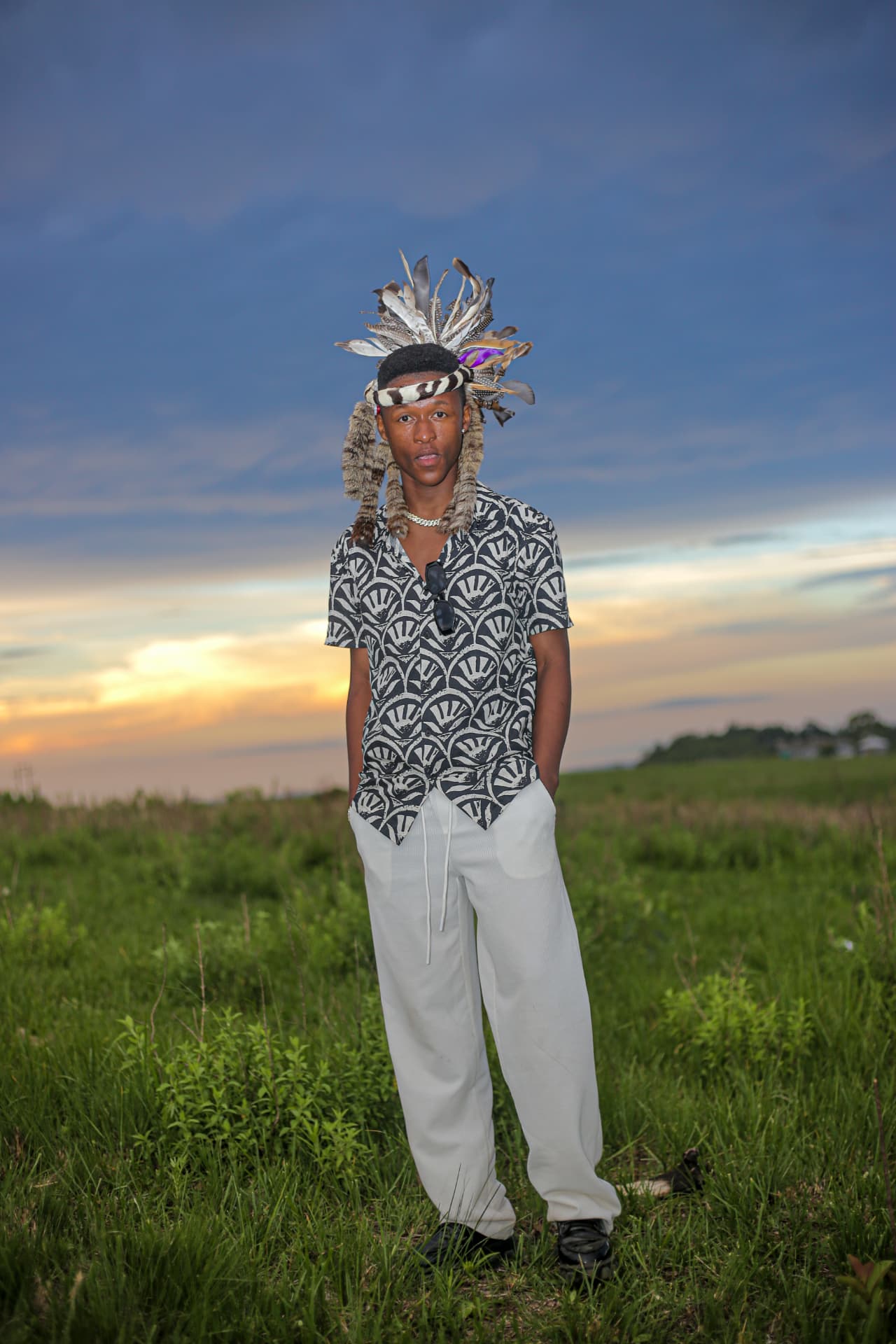 Full-length portrait in traditional headdress against a dusk sky in KwaZulu-Natal
