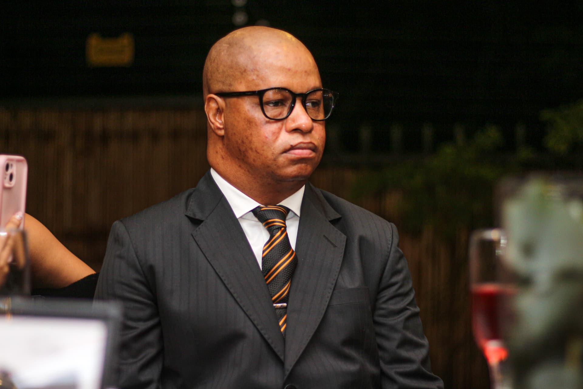 Candid portrait of the guest of honour in a suit at an evening celebration